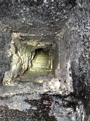 Close up of flue with creosote damage after a chimney fire