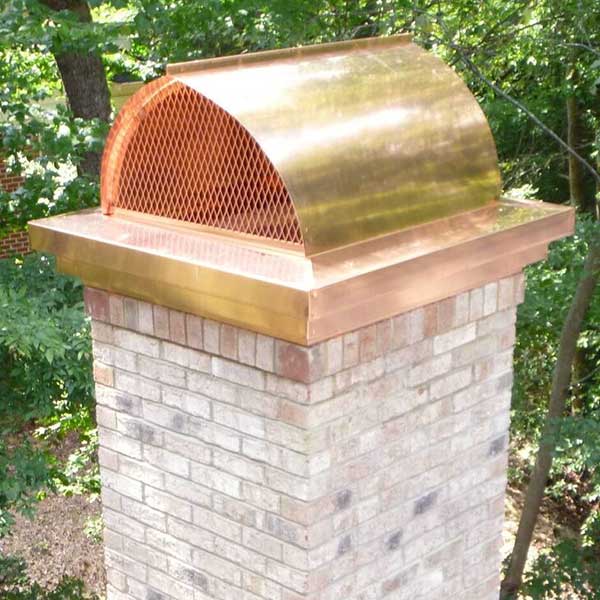 New, custom copper chimney cap installed on white washed brick chimney