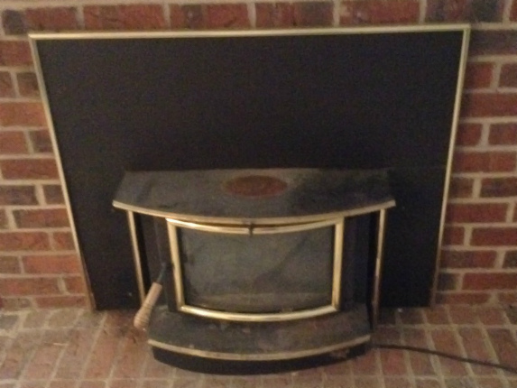 How does a fireplace insert improve fuel efficiency?