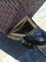 Red brick chimney with exposed damaged to flashing