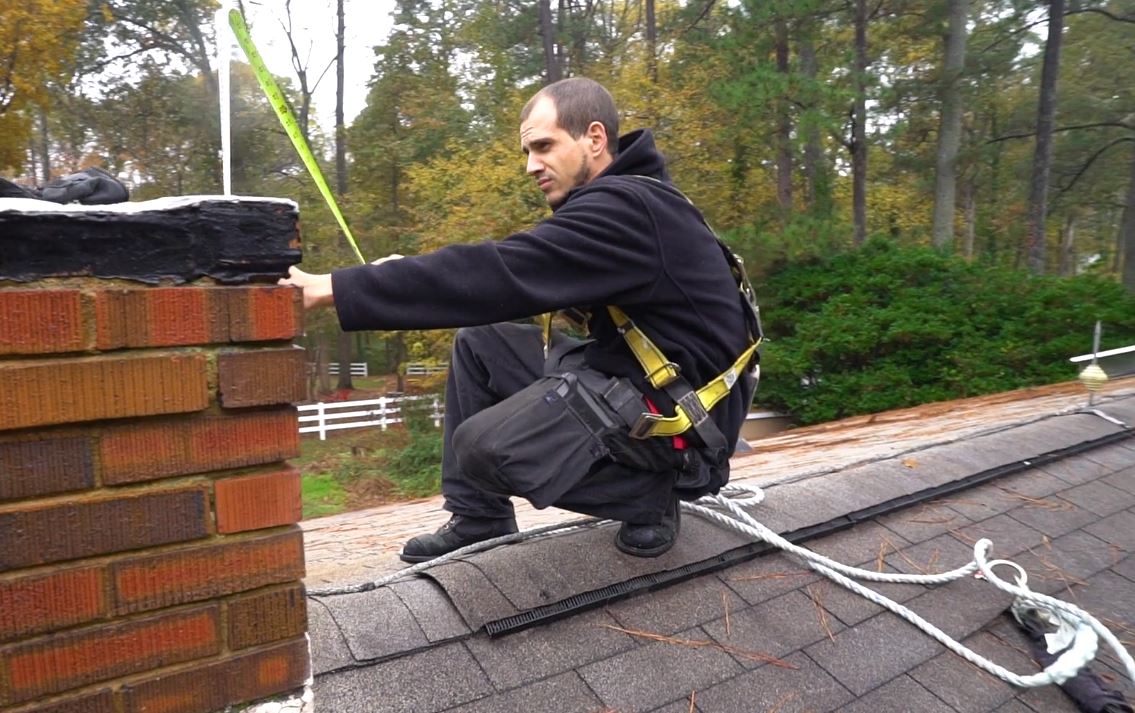mr. smokestack tech inspecting a chimney