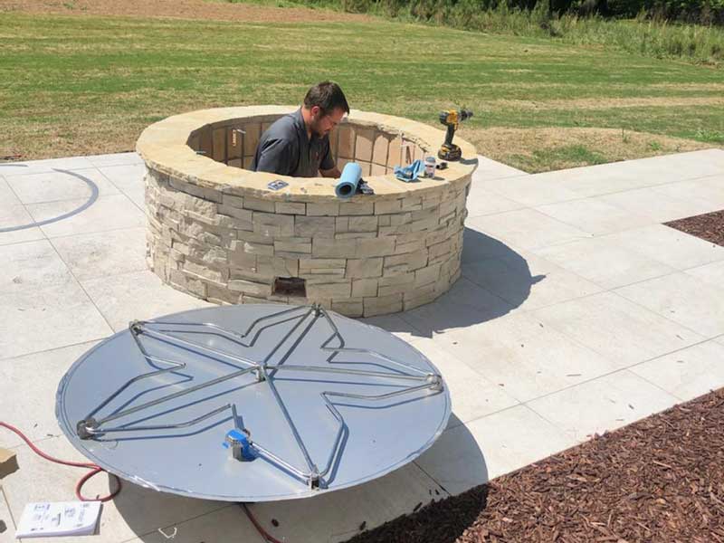 chimney technician working on custom fire pit 