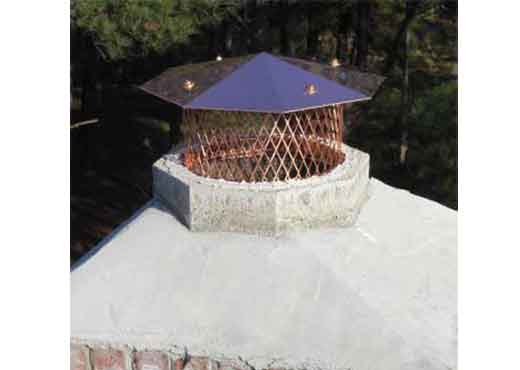 Brick chimney with newly installed custom octagon shaped copper chimney cap