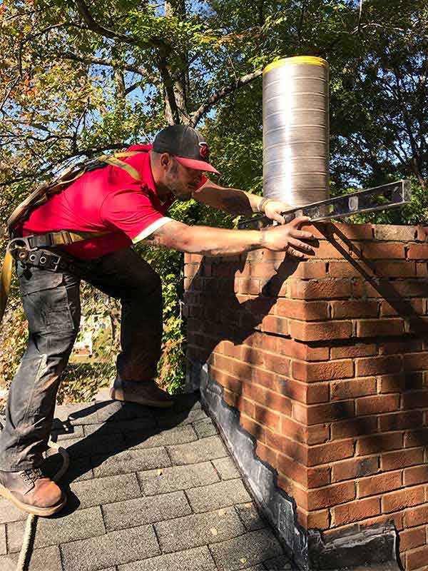 Chimney Tech Rebuilding Chimney with New Chimney Liner Sticking out of Masonry