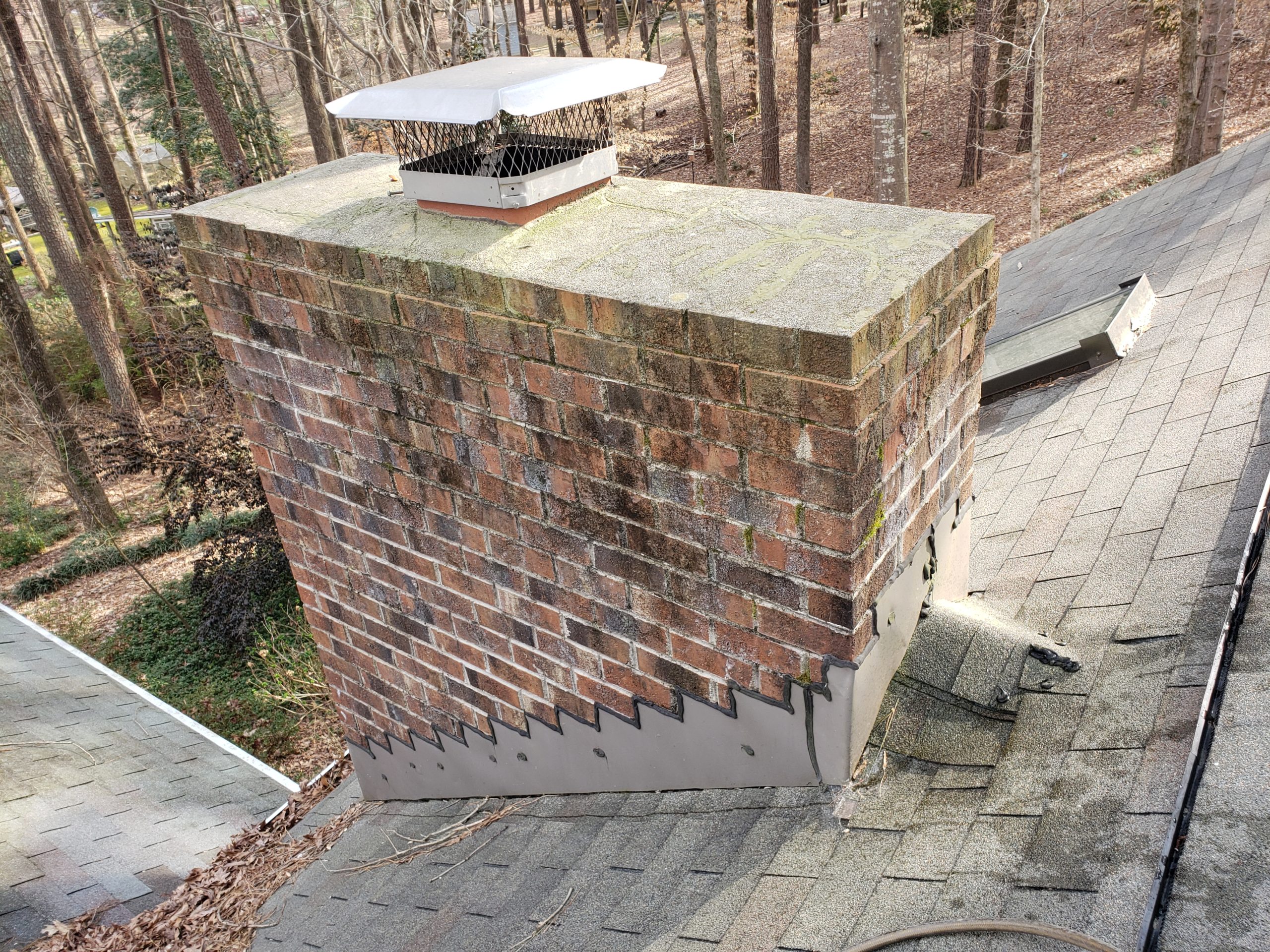 Mr Smokestack Original Photo of Dirty Chimney Before Power Washing - Broadway and Raleigh, NC Brick Chimney with dirt and green mold around crown Before Power Washing