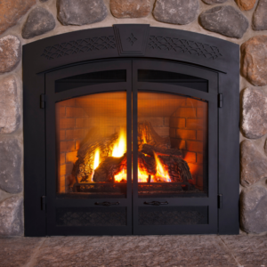 gas fireplace with gas logs and a black door