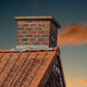 a masonry chimney against a dark blue sky