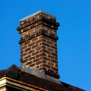 a masonry chimney against a blue sky