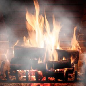 a wood fireplace fire with smoke surrounding it
