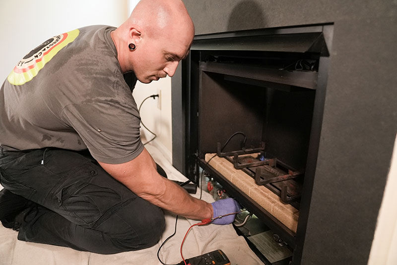 Mr Smokestack - Original image of technician Technician servicing fireplace